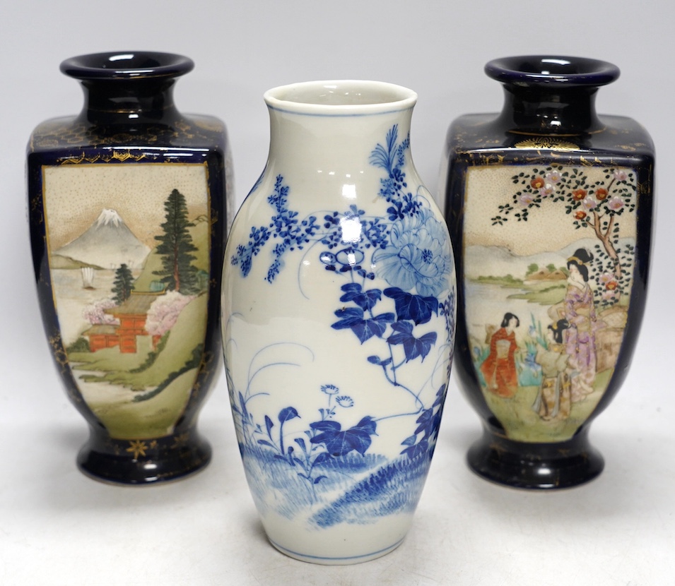 A pair of Japanese satsuma pottery vases and a blue and white Meiji Arita vase, largest 24cm high. Condition - fair